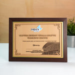 Framed certificate with 'Sapura Energy' logo on a wooden surface.