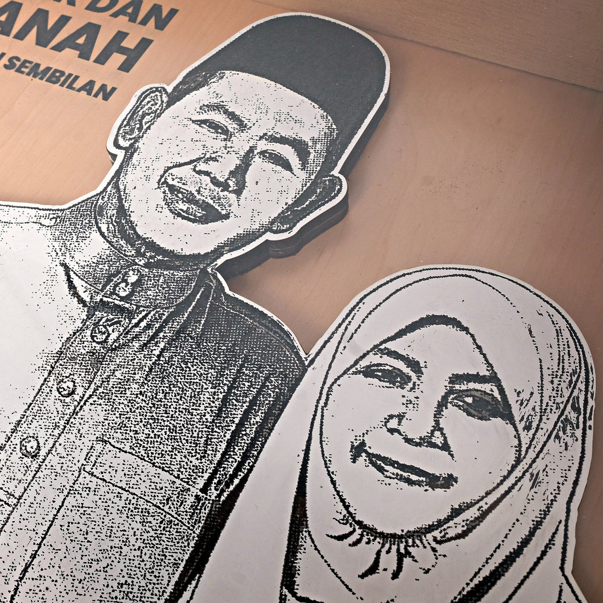 Black and white cut-out of a man and woman on a cardboard background