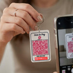 Keychain with QR code for CIMB Bank and phone scanning it