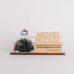 Wooden plaque with a portrait and engraved text on a white background