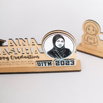 Graduation-themed wooden plaque with a photo of a person and text on a white background