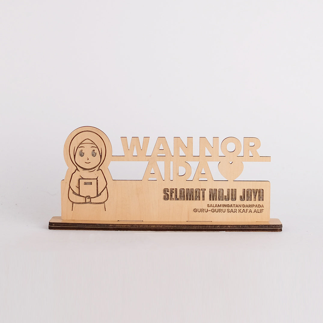 Wooden plaque with engraved text and a cartoon character on a white background