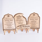 Three wooden Qurban plaques on a stand with engraved text.