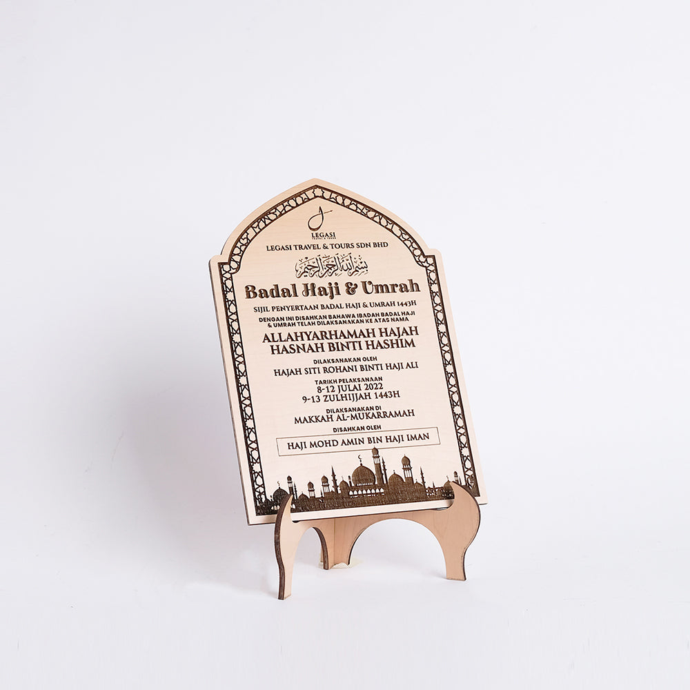 Wooden plaque with engraved text and design on a stand against a white background