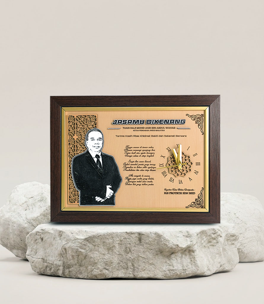 Framed portrait with text and decorative elements on a stone surface