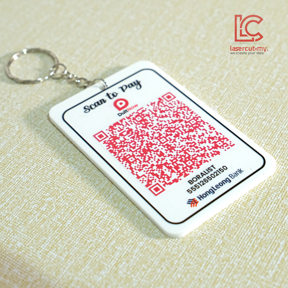 QR code keychain with branding on a beige background