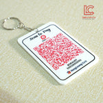 QR code keychain with branding on a beige background