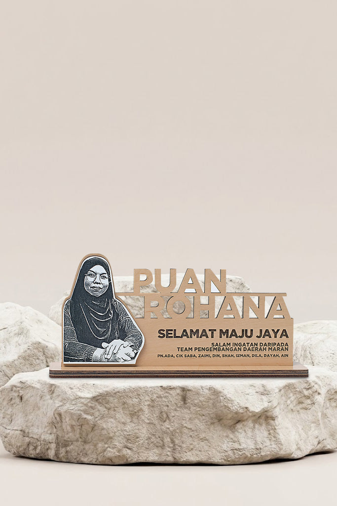 Decorative plaque with a portrait and text on a stone surface