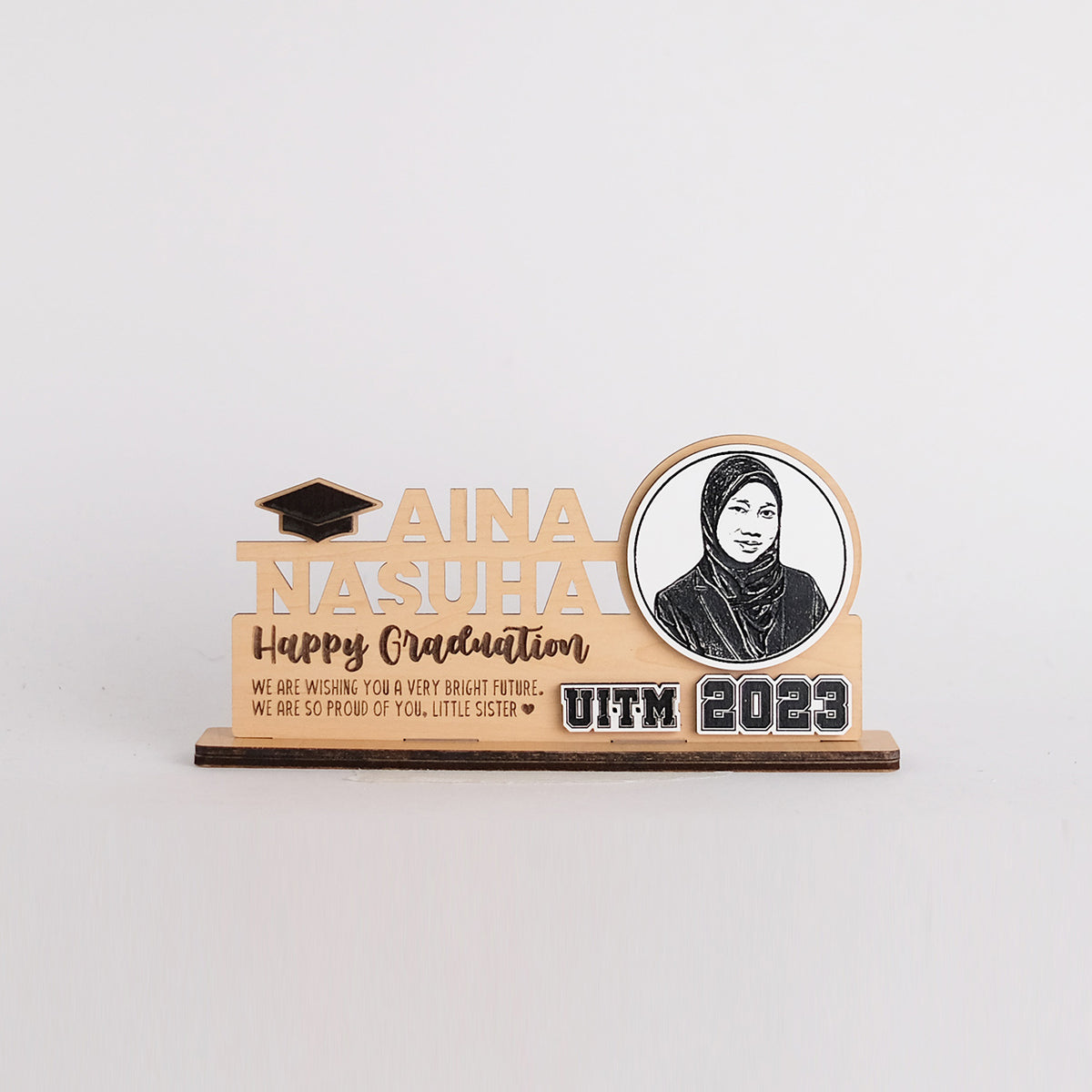 Graduation-themed decorative plaque with a photo of a person and text on a white background
